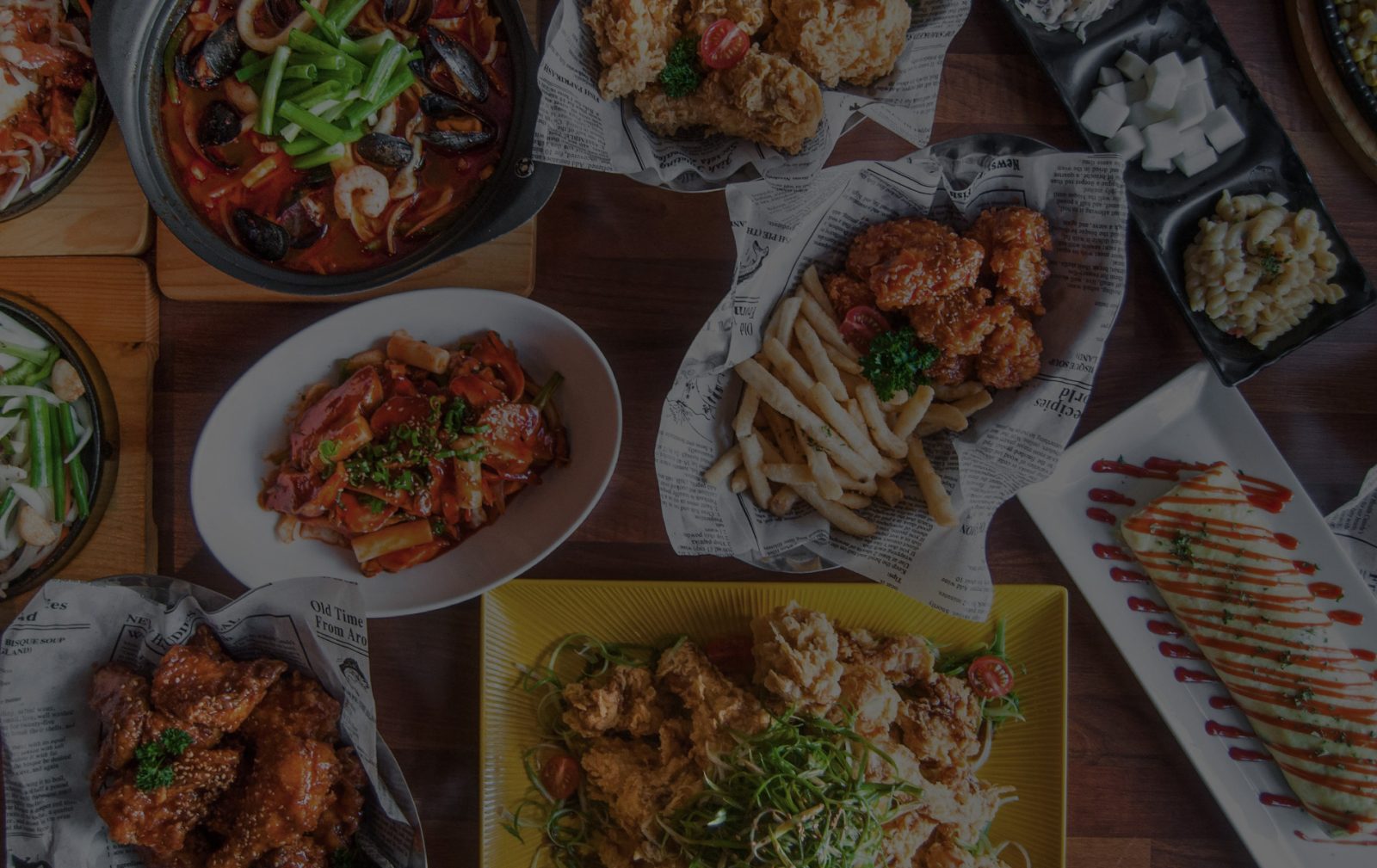 A table full of Korean fried chicken, tteokbokki and sides at The Fry